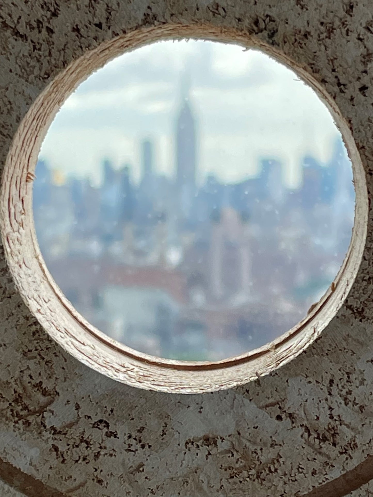 Handmade wooden circle displays with tactile texture on a steel support